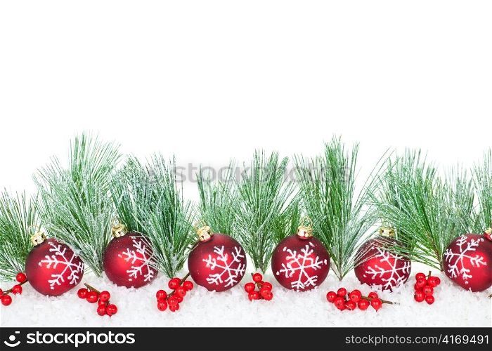 Christmas border with red ornaments and pine branches