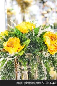 Christmas bouquet of yellow roses in a metal vase
