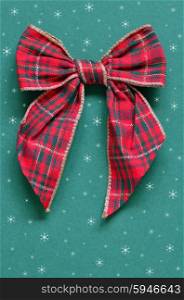 christmas bow on a green paper background