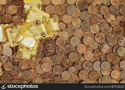 Christmas bow on a pile of coins