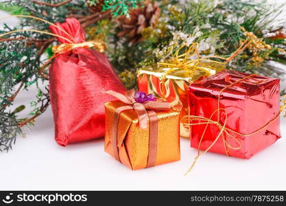 Christmas boxes and fir tree branches on gray background.