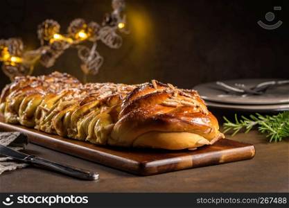 Christmas braided cinnamon cake on festive table.