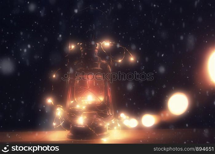 Christmas burning lantern with snowfall at night. Closeup view