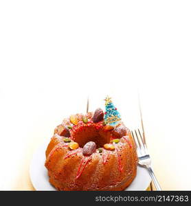 Christmas cake donut with tree as festive decoration on top over white background