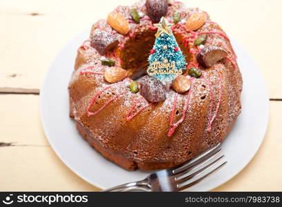 Christmas cake donut with tree as festive decoration on top over white background