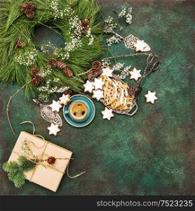 Christmas cake Stollen, star cookies, coffee and decoration. Food background. Vibrant colors. Vintage style toned picture