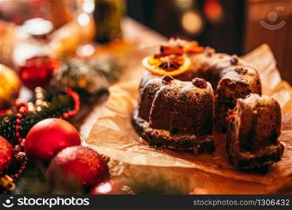 Christmas cake with holiday decoration closeup. Xmas traditional symbol, festive food, fir tree branch, red balls