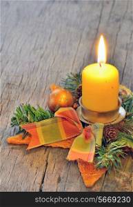 Christmas candle light on old wooden background