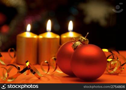 Christmas candles and red spheres. A celebratory composition