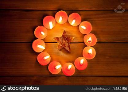 christmas candles circle over wood and bark star symbol