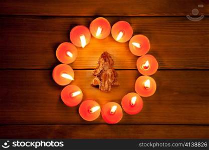christmas candles circle over wood and bark tree symbol