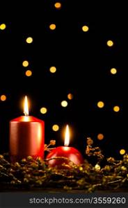 Christmas candles set against black background.