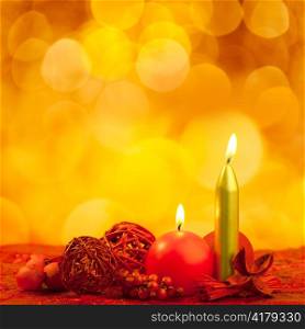 Christmas candles symbol with red dried leaves on golden background