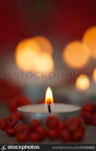 Christmas candles with berries. Decoration for holidays