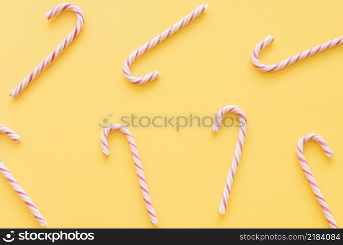 christmas candy canes yellow background