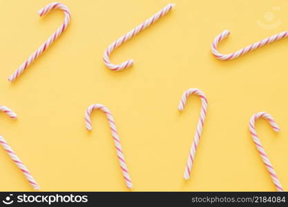 christmas candy canes yellow background
