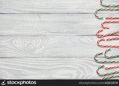 Christmas cane decoration on white wooden background