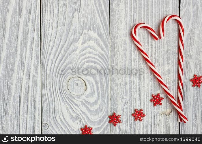 Christmas cane decoration on white wooden background