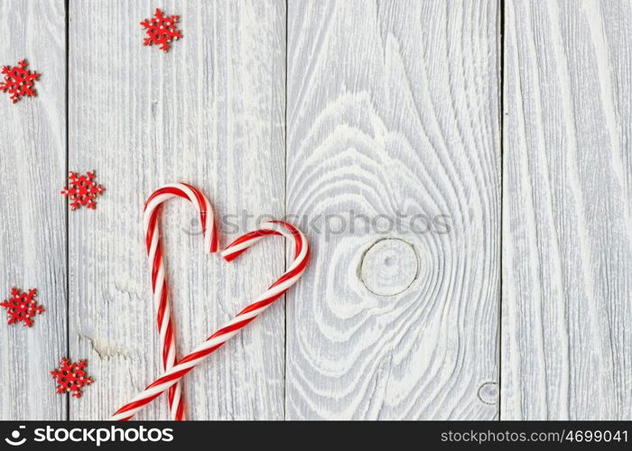 Christmas cane decoration on white wooden background