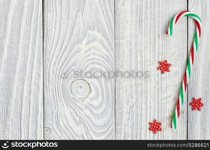 Christmas cane decoration on white wooden background