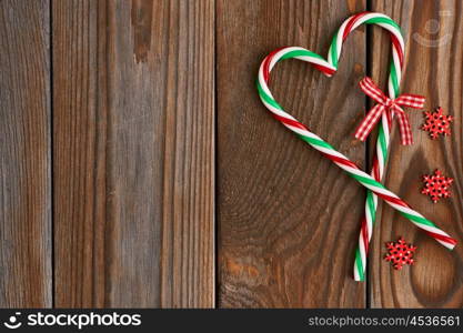 Christmas cane decoration on wooden background