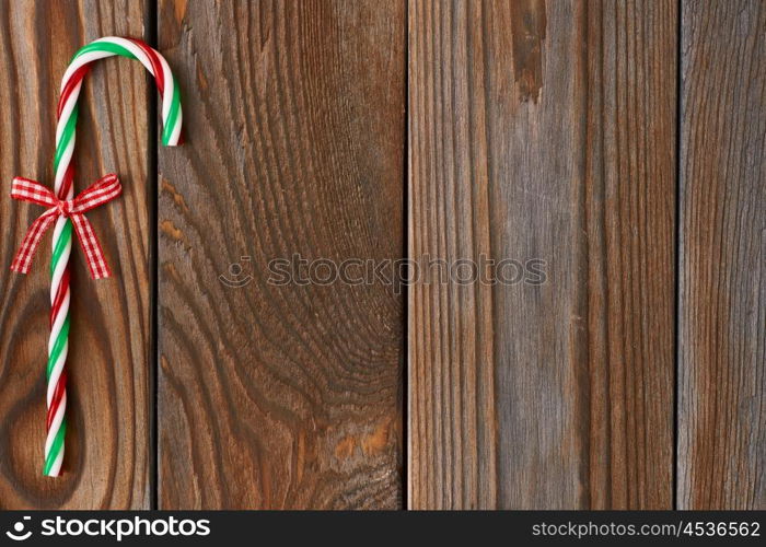 Christmas cane decoration on wooden background