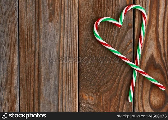 Christmas cane decoration on wooden background