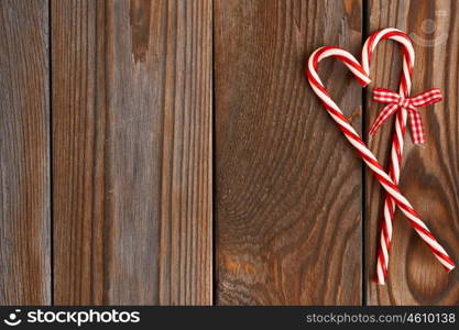 Christmas cane decoration on wooden background