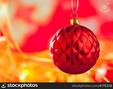 Christmas card of red capiton bauble on blur background