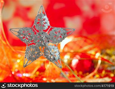 Christmas card of silver star and red blur background