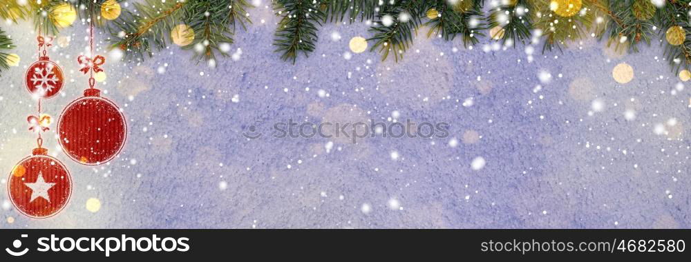 christmas card or new year background made of decorative balls handwritten on snow with fir-tree branches and red craft paper. new year background on snow