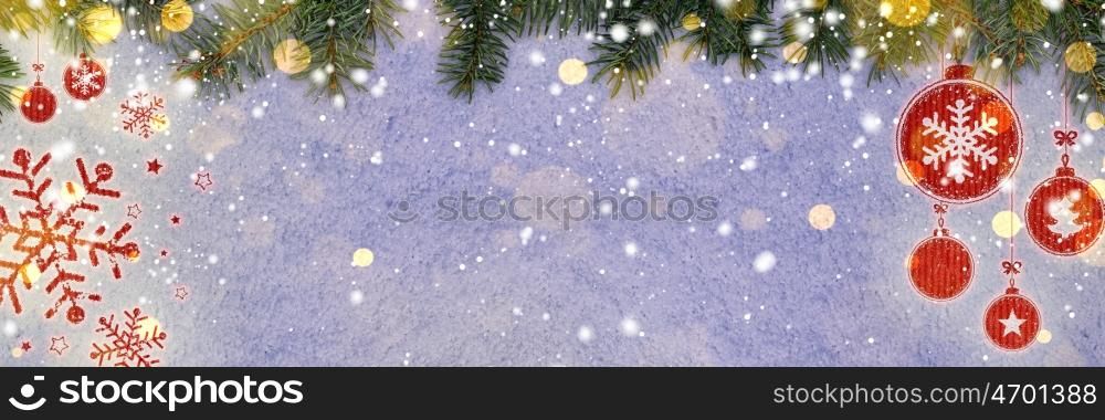 christmas card or new year background made of decorative balls handwritten on snow with fir-tree branches and red craft paper. new year background on snow