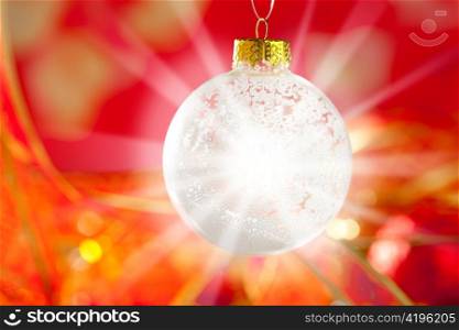 Christmas card snow bauble with snow and flare star light on red background