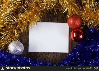 Christmas card. White blank card with decoration balls and tinsel. Place for text