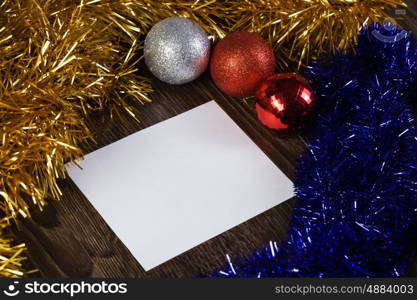 Christmas card. White blank card with decoration balls and tinsel. Place for text