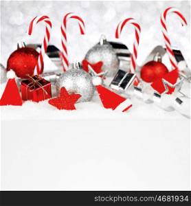 Christmas card with beautiful decorations and candies in snow