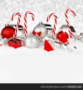 Christmas card with beautiful decorations and candies in snow