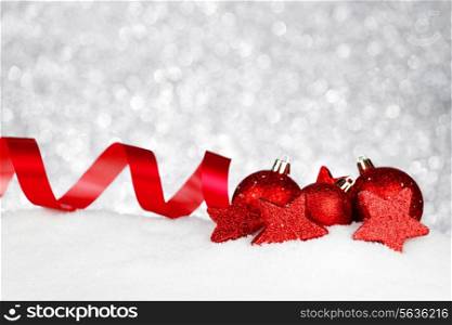 Christmas card with beautiful decorations in snow on silver background