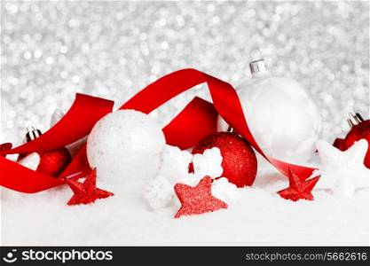 Christmas card with beautiful decorations in snow with silver background