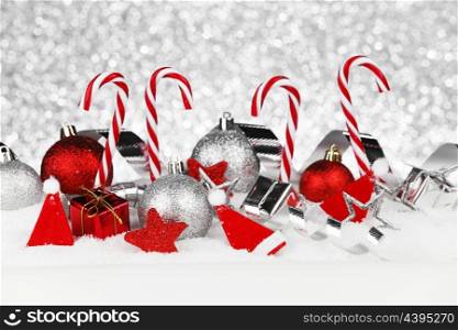 Christmas card with candies and decoration in snow