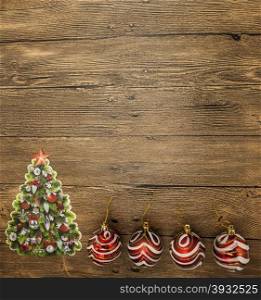 Christmas card with Christmas balls, Christmas tree on wooden background.