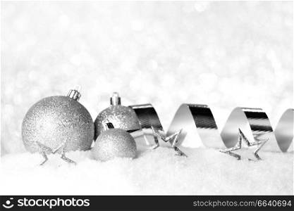 Christmas card with decorative baubles on snow