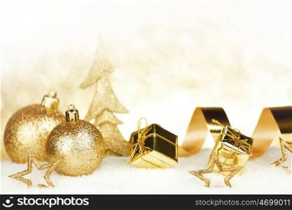Christmas card with decorative golden baubles on snow
