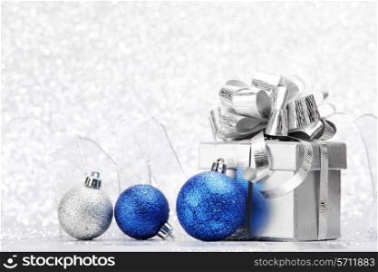 Christmas card with gift and decorative balls close-up
