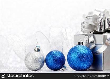 Christmas card with gift and decorative balls close-up