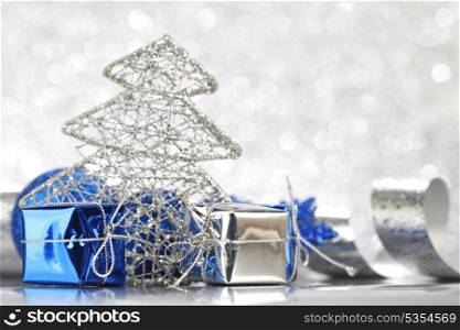 Christmas card with gifts and decoration on shiny silver background