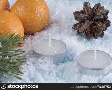 Christmas card with oranges and two candles. Greeting card with decorations and a candle