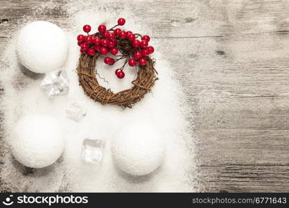 Christmas card with snowballs and snow and Christmas wreaths on the wooden background.. Christmas card with snowballs and snow and Christmas wreaths on the wooden background