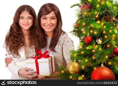 Christmas celebration at home, young mother with daughter having fun near beautiful decorated Xmas tree, receive present, happy holidays concept