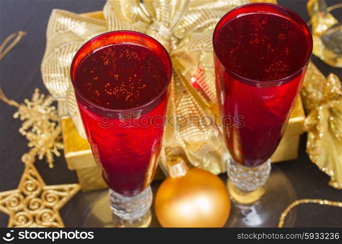 christmas champagne. christmas champagne in red glasses with golden decorations